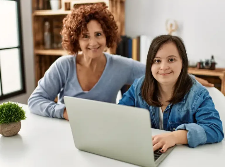 a mother with her special needs child on her laptop